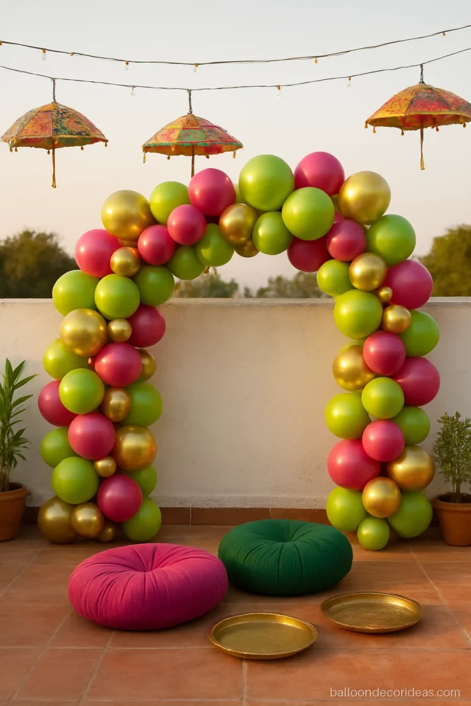 Balloon decoration for mehndi function on a terrace with green, pink and gold balloons
