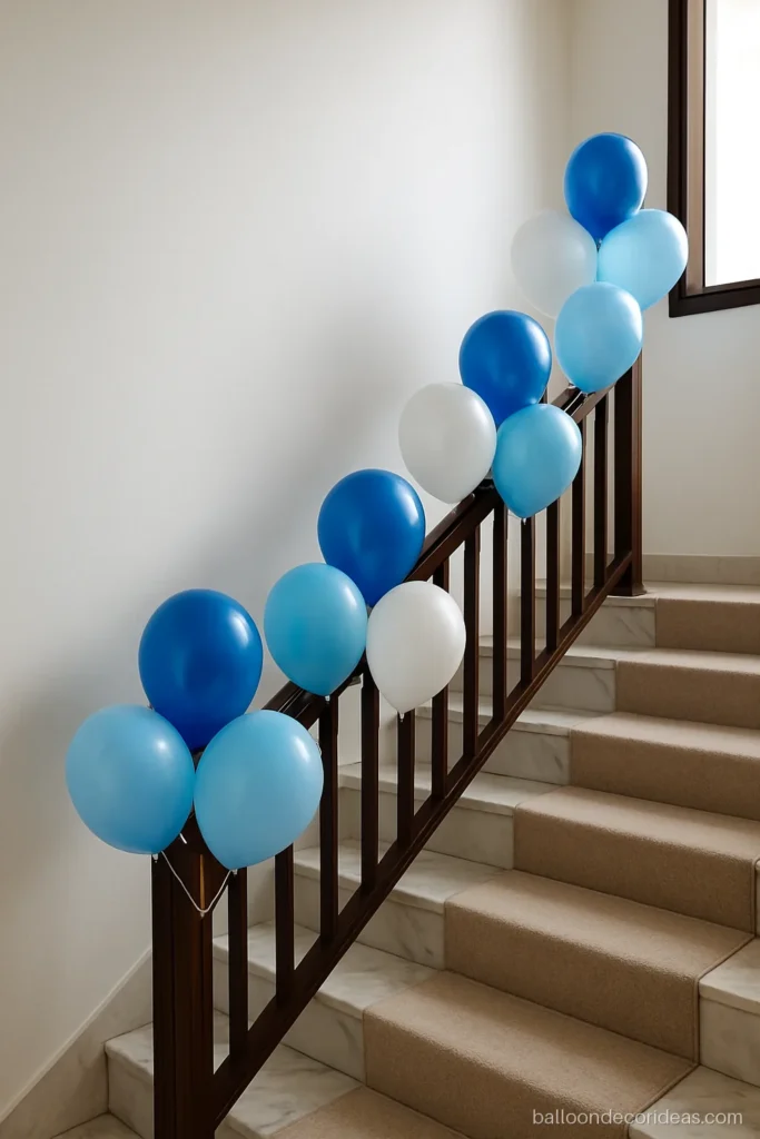 Home balloon decoration on a staircase railing with blue and white balloon clusters