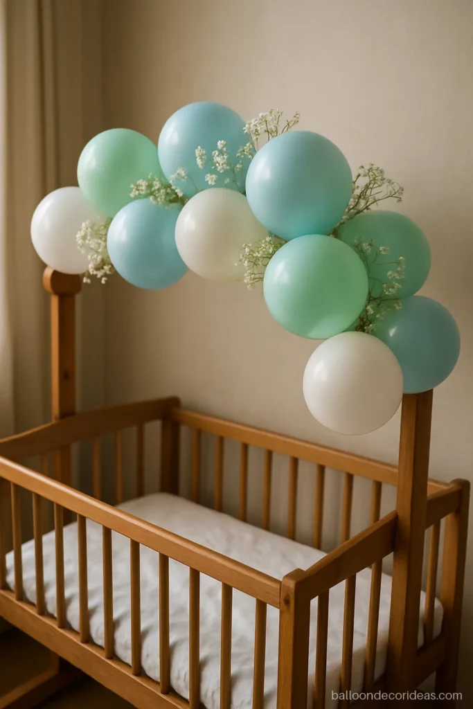 Close-up of a blue and mint cradle balloon decoration with white flowers
