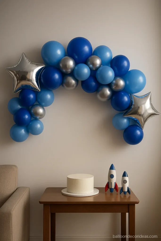 Blue silver balloon decoration garland for a boy's birthday on a white wall