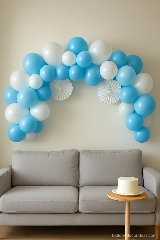 Simple blue and white balloon decoration garland over a sofa for a birthday
