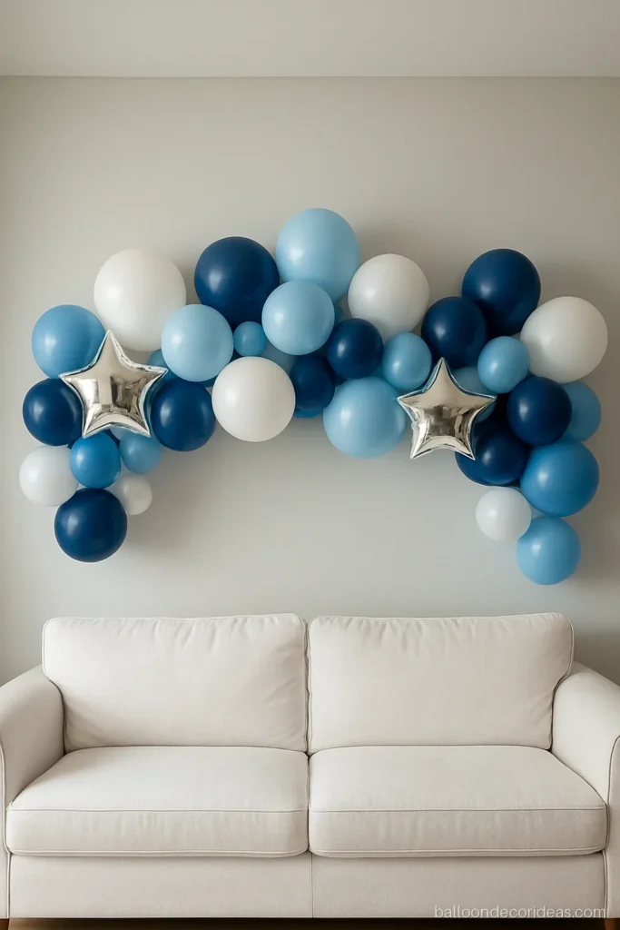 Blue and white balloon decoration garland over a sofa for a boy's birthday