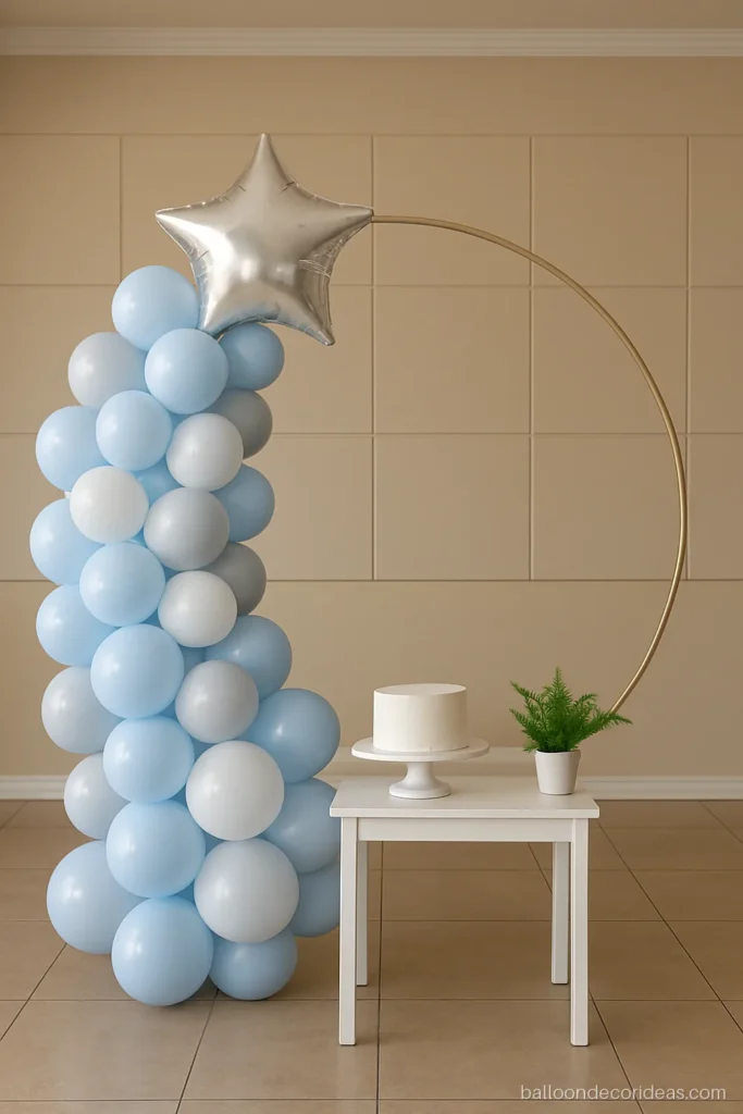 First birthday balloon ring backdrop in baby blue and white with a plain silver foil