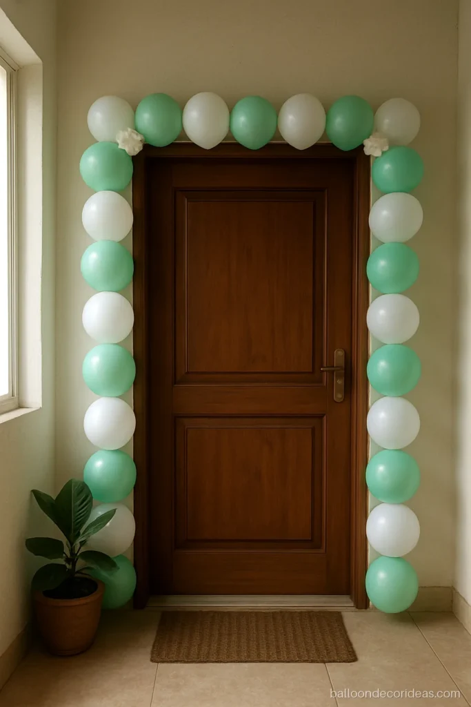 Easy balloon decoration with a green and white trail along a door frame
