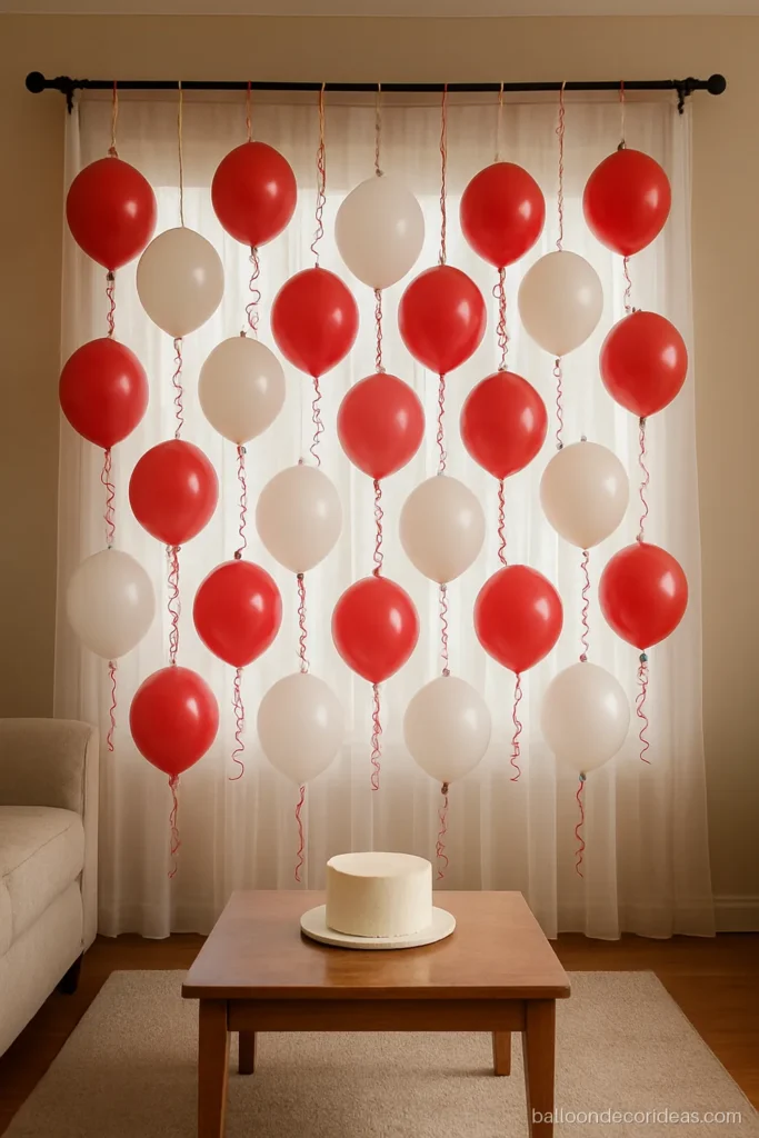 Small balloon decoration with red and white balloons on curled ribbon strings